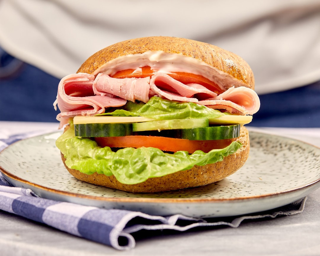 A ham and salad sandwich on a whole-grain bun.